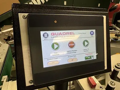Quadrel model Q110 pressure sensitive wraparound labeler