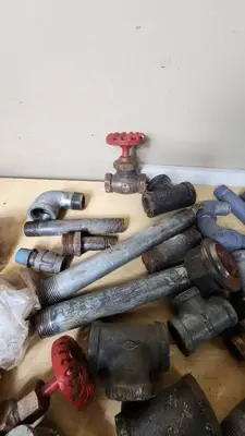Lot of Plumbing Hardware and Fittings including Galvanized Nipples, Elbows, Valves, and Connectors