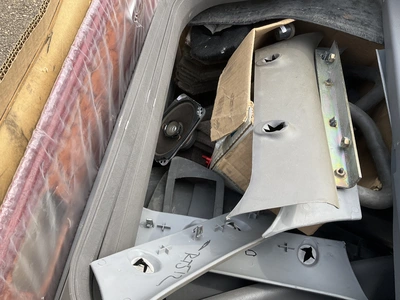 Skid of used semi truck truck interior parts including dash panels, trim, climate control panels, ve...