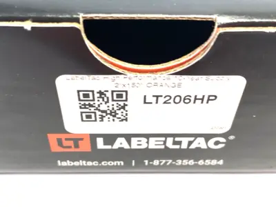 USED LABELTAC PRO MODEL HIGH PERF. 10 YEAR VINYL LABEL ORANGE, 2"X 150'/ ROLL