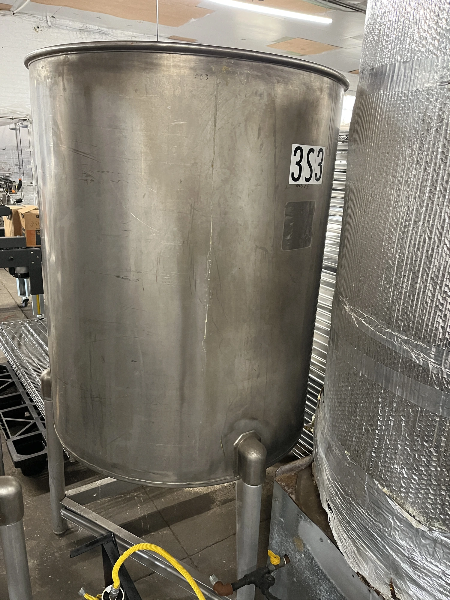 Used approximately 230 gallon stainless steel vertical tank