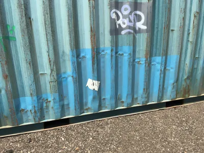 20’ Shipping / Storage Container 8’ wide x 8’ 6” tall, swing doors on one end, wood deck, rings for ...