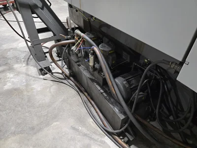 Hyundai HI-V50D VMC w/ 30-Slot ATC, Conveyor, (2) Kurt Vise, Fanuc Oi-MC Controller