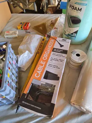 Assorted Office and Craft Supplies including Giant Pencil Decor, Cable Organizer, Glue Stic Foam Cushion Roll, and Miscellaneous Tools