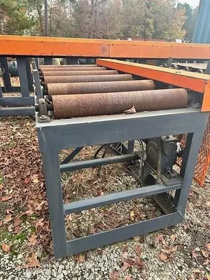 Used Grey Powered Conveyor with load staging on side