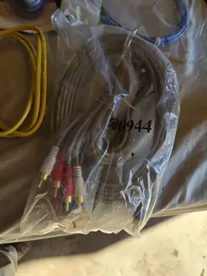 Various audio, video, and network cables, including RCA stereo audio cables, CAT6 network cables, VGA extension cables, USB printer cables, and more.