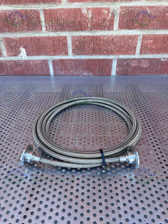 USED FLEXIBLE 200" STAINLESS STEEL BRAIDED HOSE W/ 1"  SANITARY FITTING