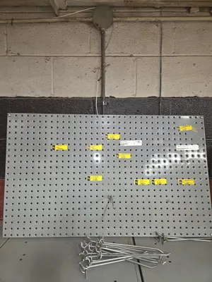 Hose clam rack, peg board with approximately 25 pegs, wire rack, rod rack with misc threaded rod.