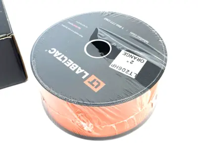 USED LABELTAC PRO MODEL HIGH PERF. 10 YEAR VINYL LABEL ORANGE, 2"X 150'/ ROLL