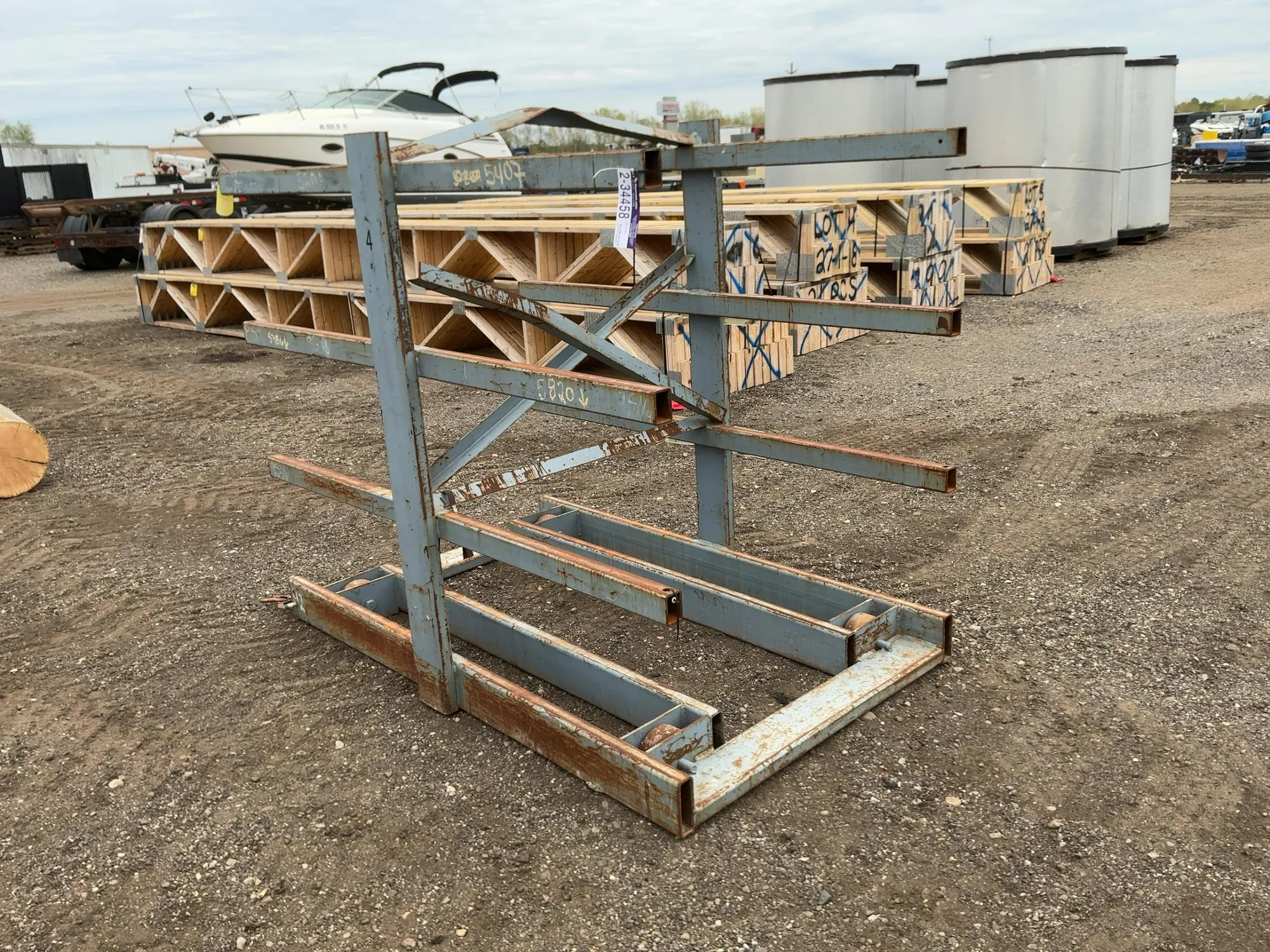 Metal Two Sided Cantilever Rack, on wheels so it can roll sideways (wheels are missing outer coating...