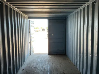 20’ Shipping / Storage Container 8’ wide x 8’ 6” tall, swing doors on one end, wood deck, rings for ...