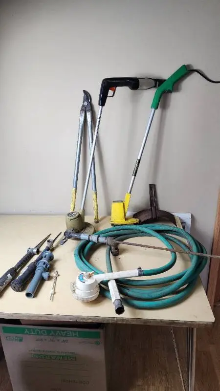 Garden Tools and Equipment including Weed Eater Grass Trimmer, Hose, and Accessories