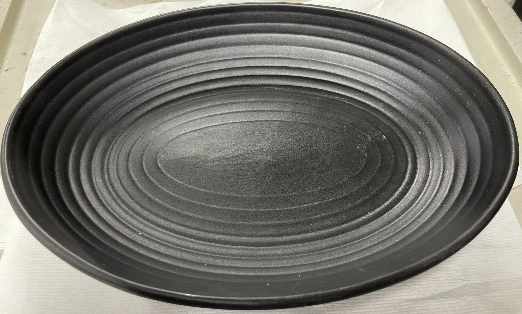 Used Tuxton Used Tuxton TuxTrendz Zion Matte Black 35 oz. Embossed Oval China Bowl - WO1 Smallwares Illinois US | Falcon Restaurant Supply #1375421