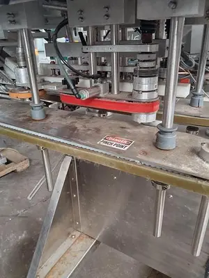 Inline Filling Systems capper with Waterfall feeder