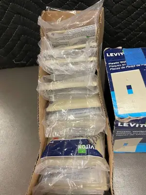 Box of 10 Leviton Ivory Nylon Midway Wallplates and box of Plastic wallplates.