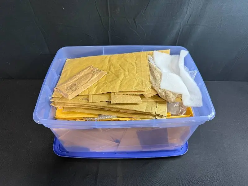 Collection of Padded Mailing Envelopes and Bubble Mailers in Storage Bin