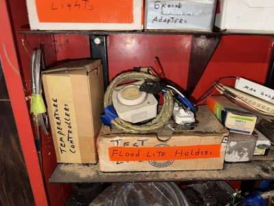 (2) Auto Call single door storage cabinets filled with assorted electrical items, including Push Mat...