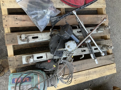 Skid lot of 4 piece swivel casters with bumpers, pulley with cord and remote, a snow scraper, a trac...