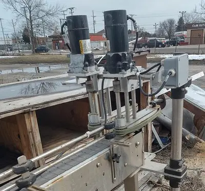 Inline Filling Systems capper with Waterfall feeder