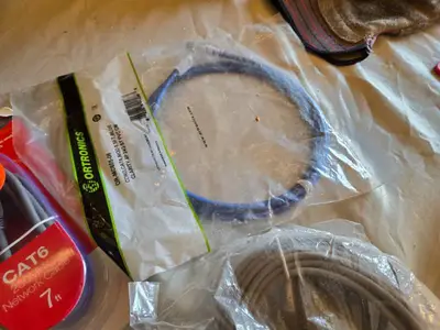 Various audio, video, and network cables, including RCA stereo audio cables, CAT6 network cables, VGA extension cables, USB printer cables, and more.