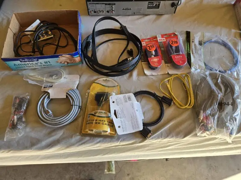Various audio, video, and network cables, including RCA stereo audio cables, CAT6 network cables, VGA extension cables, USB printer cables, and more.