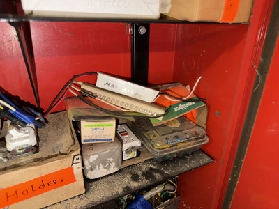 (2) Auto Call single door storage cabinets filled with assorted electrical items, including Push Mat...