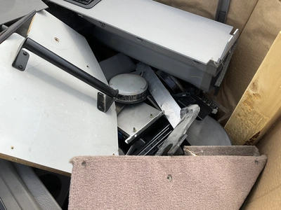 Skid of used semi truck truck interior parts including dash panels, trim, climate control panels, ve...
