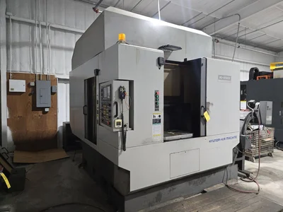 Hyundai HI-V50D VMC w/ 30-Slot ATC, Conveyor, (2) Kurt Vise, Fanuc Oi-MC Controller