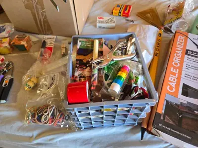 Assorted Office and Craft Supplies including Giant Pencil Decor, Cable Organizer, Glue Stic Foam Cushion Roll, and Miscellaneous Tools