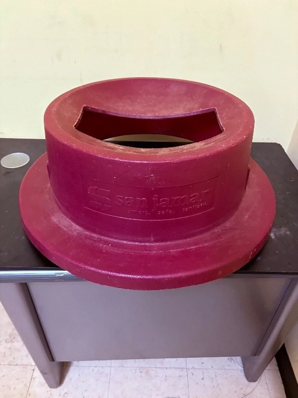 Trash can lid with magnetic silverware catcher