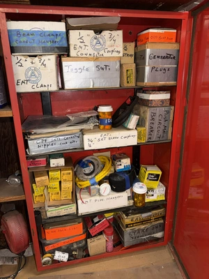 (2) Auto Call single door storage cabinets filled with assorted electrical items, including Push Mat...
