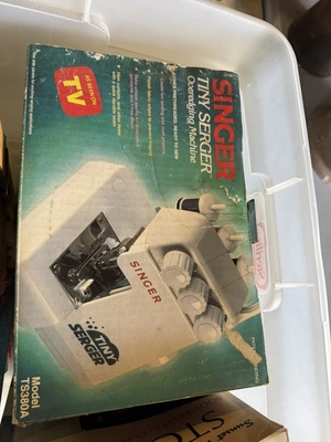 (1) Singer Tiny over edging machine, assorted patterns, and sewing items.