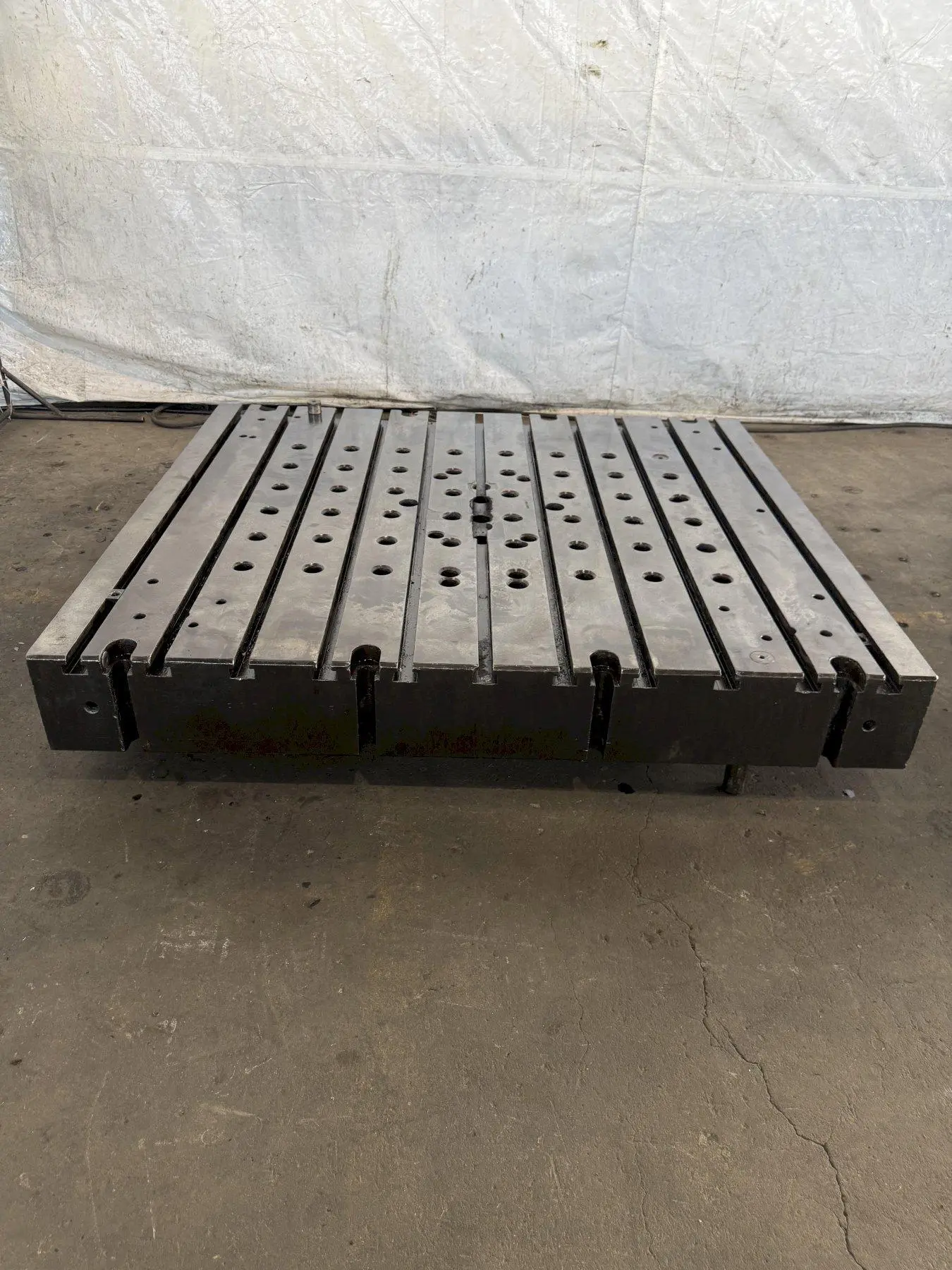 60" WIDE X 67" LONG X 9" THICK T-SLOTTED BOLSTER PLATE. STOCK # 1006324