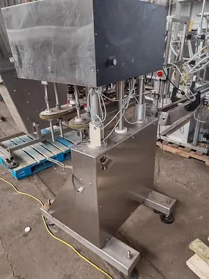 Inline Filling Systems capper with Waterfall feeder