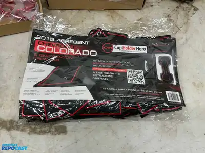 Box of various car parts and accessories including: red and black rearm rest covers, Chevy...