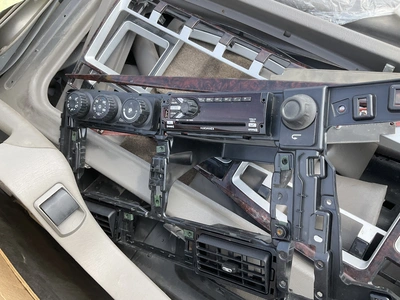 Skid of used semi truck truck interior parts including dash panels, trim, climate control panels, ve...