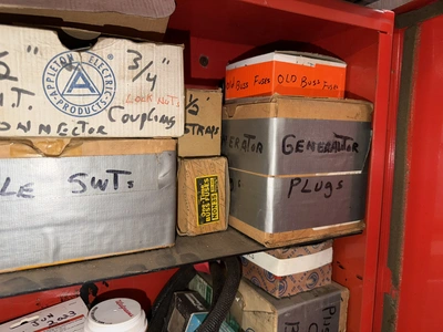 (2) Auto Call single door storage cabinets filled with assorted electrical items, including Push Mat...