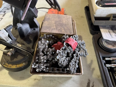 (1) Oregon chainsaw sharpener with assorted chainsaw chain.