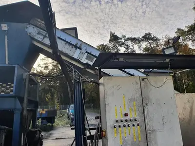 Briquetting machine for the production of charcoal briquettes including a hot air generator and conveyor