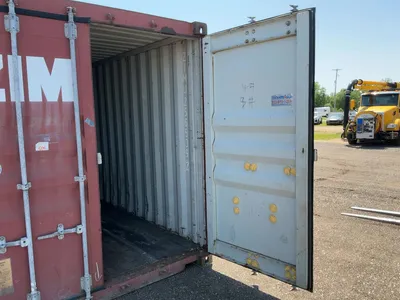 20’ Shipping / Storage Container 8’ wide x 8’ 6” tall, swing doors on one end, wood deck, rings for ...
