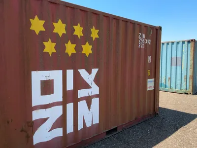 20’ Shipping / Storage Container 8’ wide x 8’ 6” tall, swing doors on one end, wood deck, rings for ...