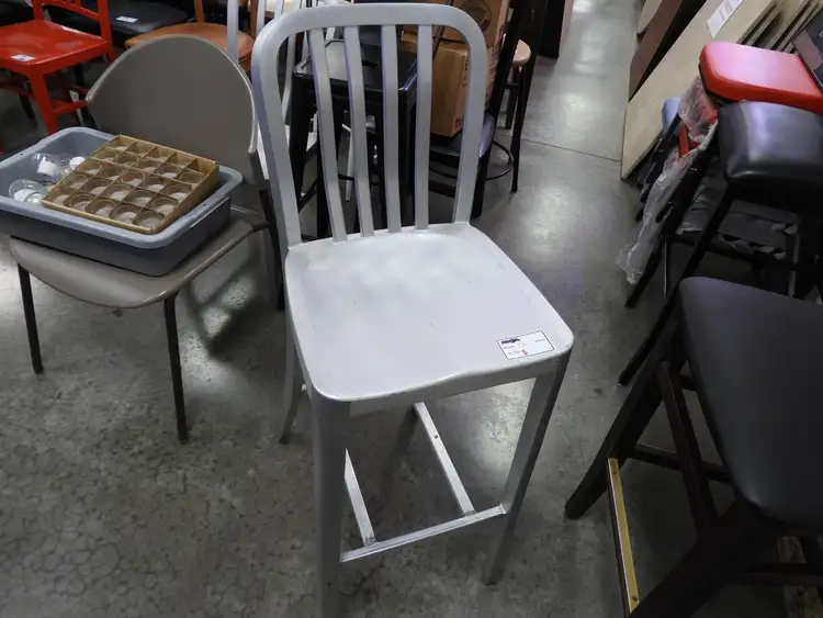 Used Falcon Restaurant Supply Used Aluminum Light Weight Silver Navy Indoor / Outdoor Bar Height Stool with Vertical Slat Back Restaurant Front of House Furnishings Illinois US | Falcon Restaurant Supply #1376610