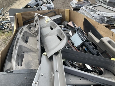 Skid of used semi truck truck interior parts including dash panels, trim, climate control panels, ve...