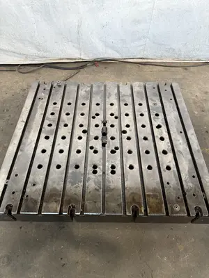 60" WIDE X 67" LONG X 9" THICK T-SLOTTED BOLSTER PLATE. STOCK # 1006324