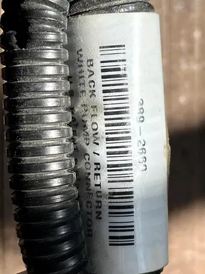 CAT Part # 506-5802.  BACK FLOW / RETURN WHITE PUMP CONNECTOR.  NEW.