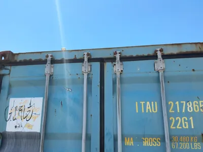 20’ Shipping / Storage Container 8’ wide x 8’ 6” tall, swing doors on one end, wood deck, rings for ...
