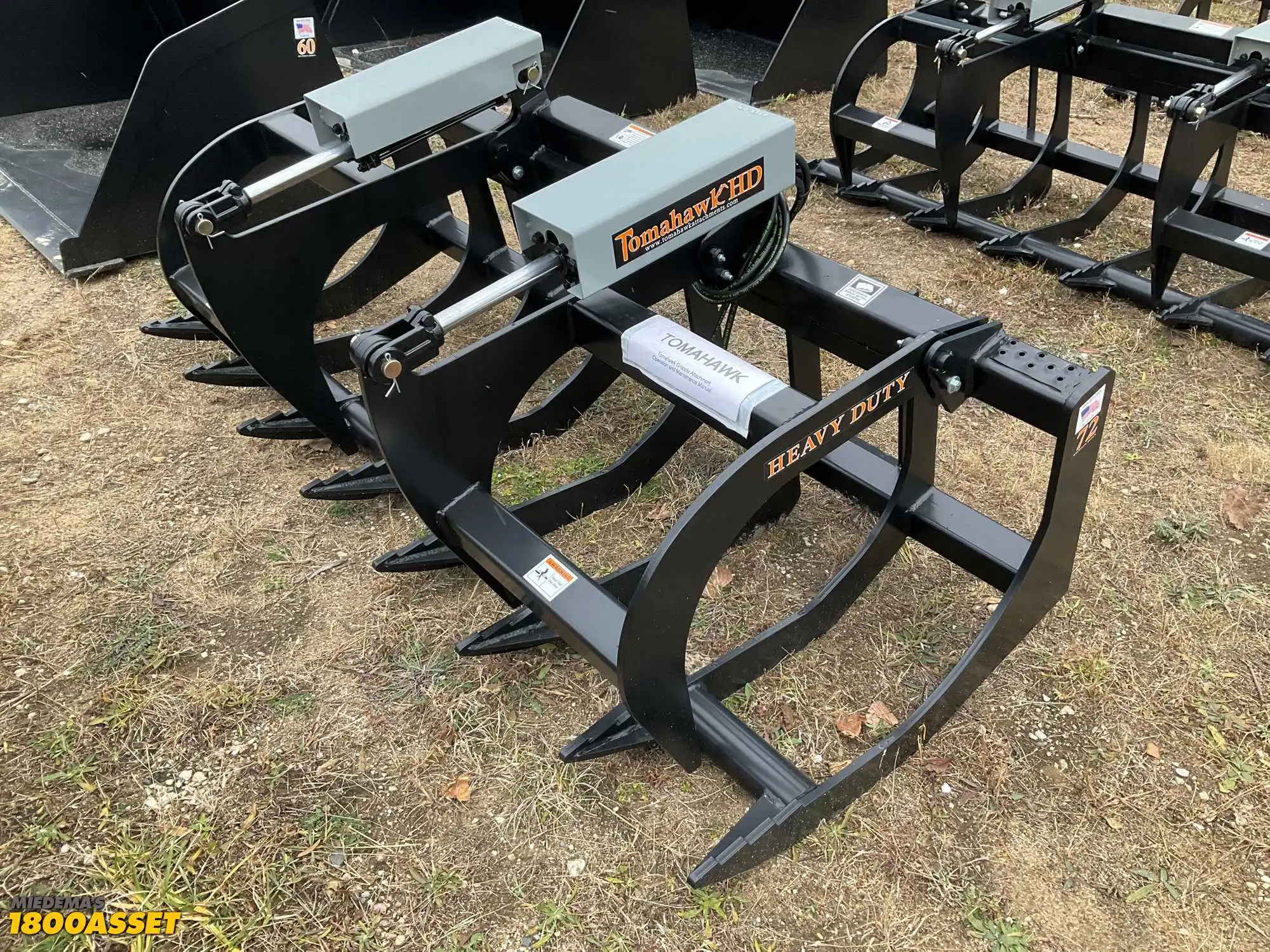 New Tomahawk 72” brush grapple attachment, two hydraulic grapple arms, skid steer quick attach