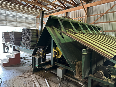 6 strand, 120' green chain with incoming deck and hoist. 24 heavy duty carts
