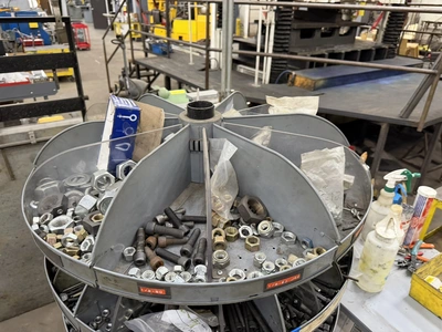 (1) 7-tier lazy Susan style parts rack, approx. 66" tall, includes assorted socket head cap screws, ...