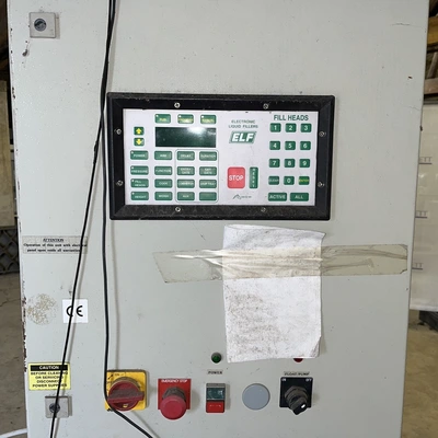 6 Head ELF Filler with feed tanks & container link belt conveyor
